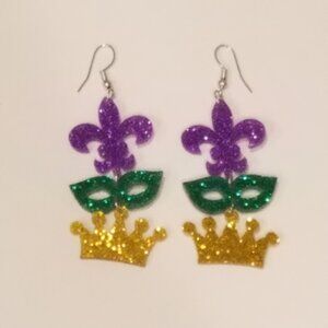 Glitter acrylic purple fleur-de-lis, green mask, and gold crown dangle earrings